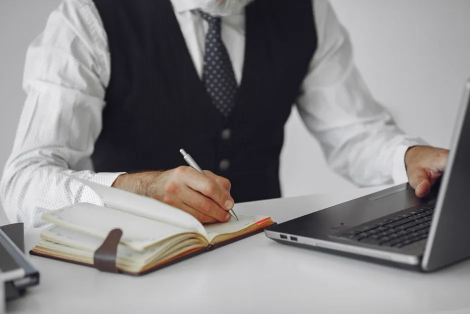 Person writing in a journal, representing urge logging and reflection